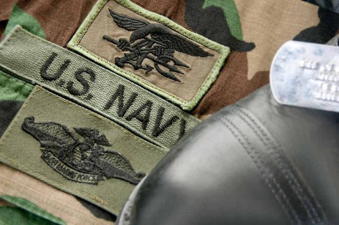 U.S. Navy badges on camouflage uniform with boot.