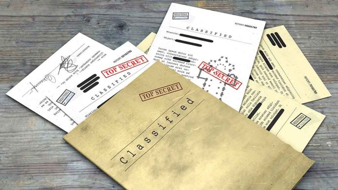 Classified documents with "Top Secret" stamps on wooden surface.