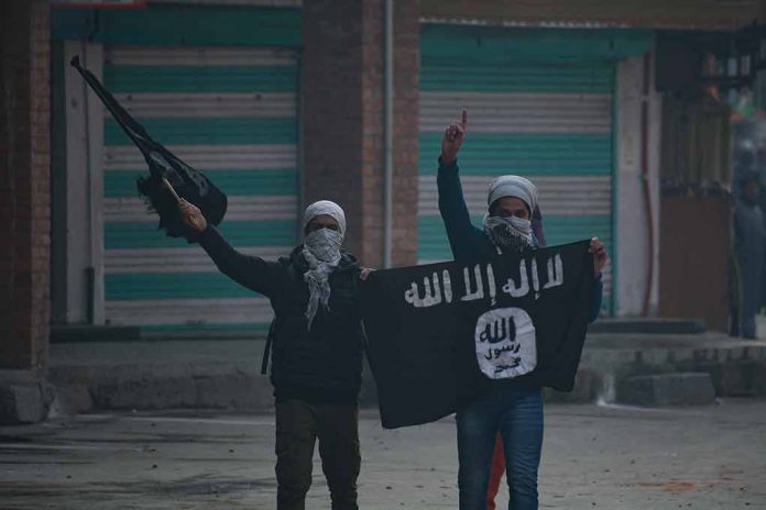 People holding and waving a black flag.