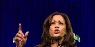 Woman speaking passionately at a podium.