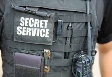 Secret Service vest with various tactical gear attached.