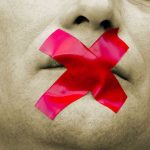 Man with red tape over mouth.