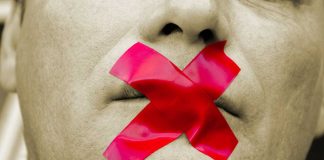 Man with red tape over mouth.