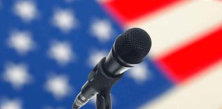 Microphone with American flag in the background.