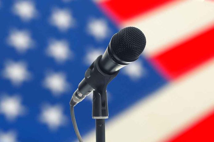 Microphone with American flag in the background.