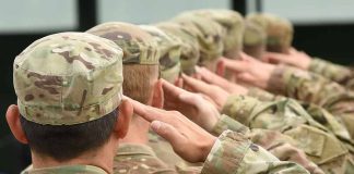 Soldiers in uniform saluting, American flag patch visible.