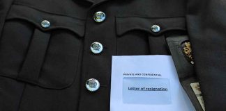 Police uniform with a resignation letter.