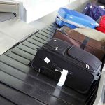 Suitcases on an airport baggage carousel.