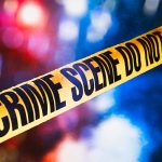 Yellow crime scene tape with blurred background lights