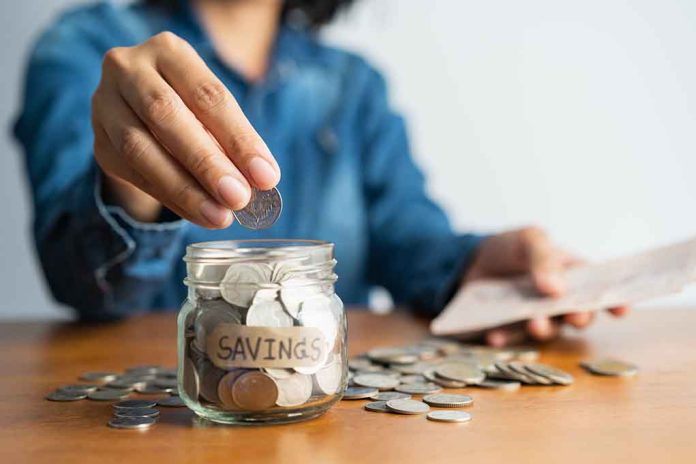 Person adding coins to a savings jar