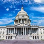 U.S. Capitol building with clear blue sky background.