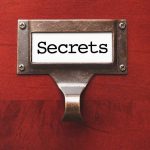 Label holder with the word "Secrets" on red background.