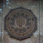 FBI seal on a granite wall.