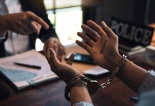 Handcuffed person in police station during interrogation