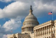 US Capitol Building with American flags and clouds