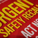 "Urgent safety recall sign in bold letters."