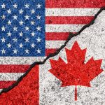 USA and Canada flags divided by jagged crack