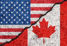 USA and Canada flags divided by jagged crack