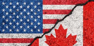 USA and Canada flags divided by jagged crack