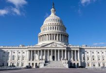 U.S. Capitol building under a clear blue sky.