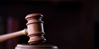 Wooden gavel on a dark background.