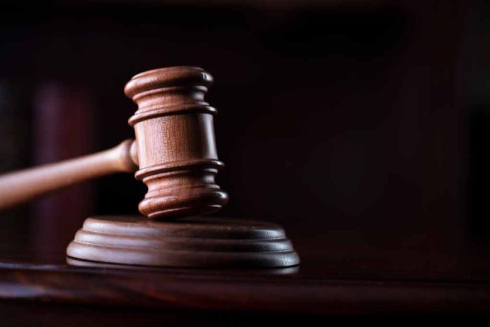 Wooden gavel on a dark background.