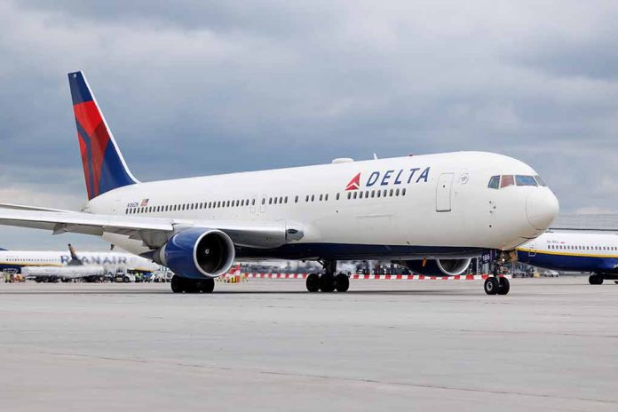 Delta Airlines airplane on airport runway, cloudy sky.