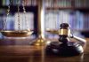 Gavel and scales of justice on desk.