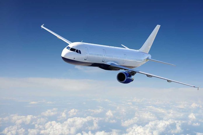 Airplane flying above the clouds in blue sky