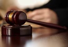 Wooden gavel resting on a judge's desk.