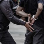 Police officer arresting a person.