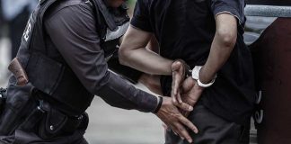 Police officer arresting a person.