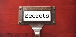 Label holder with the word Secrets on red background.