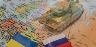 Tank on map with Ukraine and Russia flags