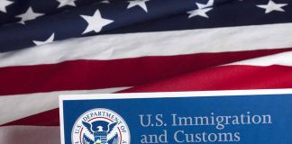 US flag with Immigration and Customs Enforcement sign