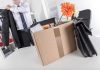 Cardboard box with office items and flowers