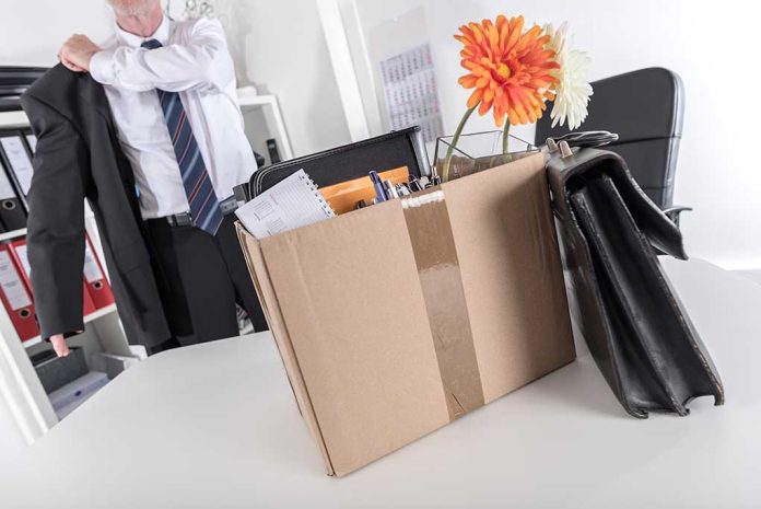 Cardboard box with office items and flowers