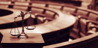 Scales of justice in an empty courtroom.