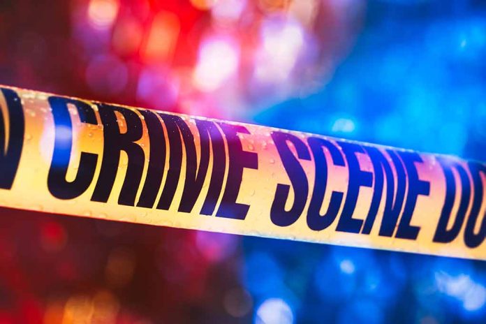1019899543 featured image Yellow crime scene tape with blurred lights background