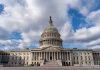Capitol building under a cloudy blue sky