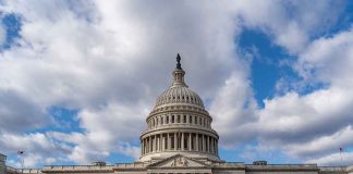 Capitol building under a cloudy blue sky