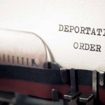 Typewriter typing deportation order paper document