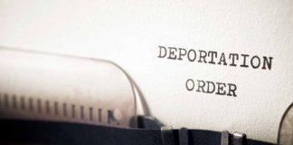 Typewriter typing deportation order paper document