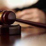Gavel resting on a wooden sound block