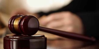 Gavel resting on a wooden sound block