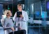 Woman undergoing brain scan with doctor monitoring results
