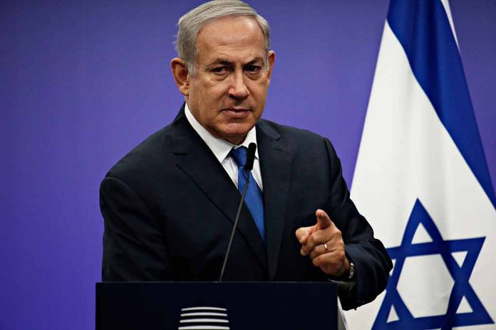 1042782061 featured image Man speaking at podium with Israeli flag behind him