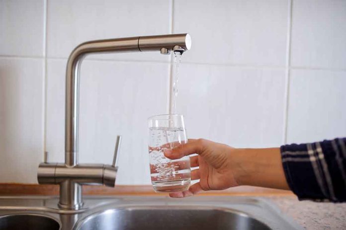 1128611180 featured image Hand filling glass with water from faucet.