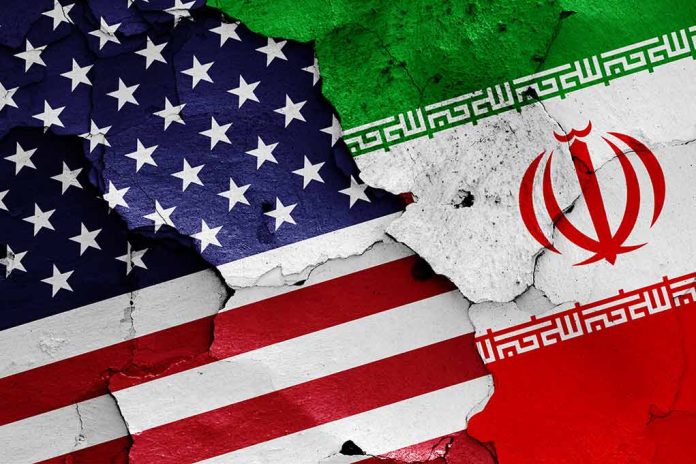 1152300314 featured image Cracked American and Iranian flags on concrete background