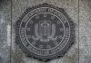 FBI seal on granite wall displaying department motto